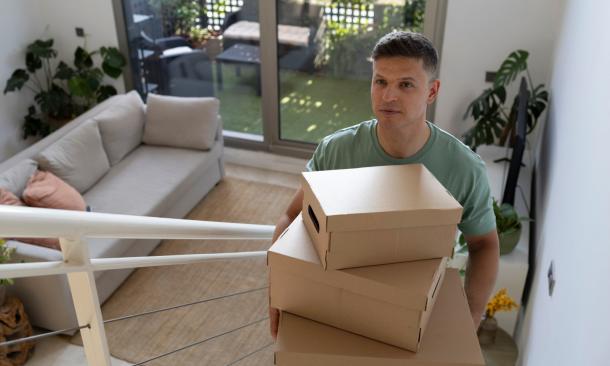 A man carrying his valuables upstairs
