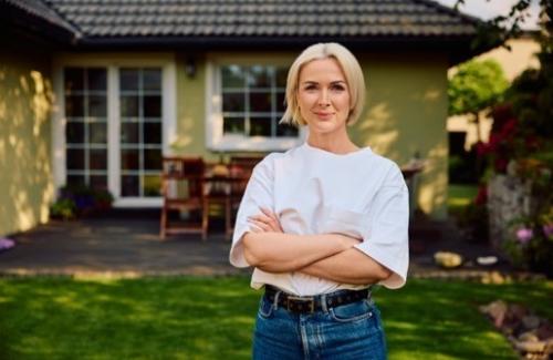 Confident women in front of home that is prepared for flooding