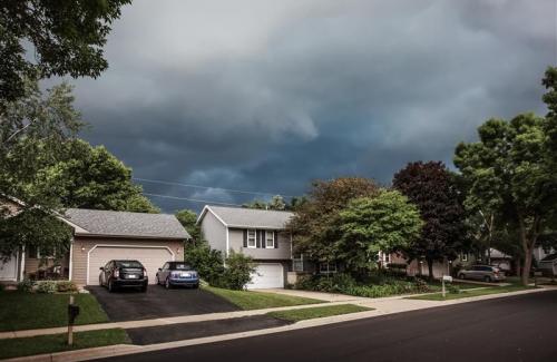 Suburban houses under storm clouds