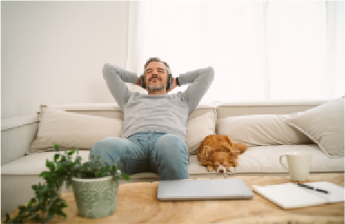 Man relaxing on couch with dog