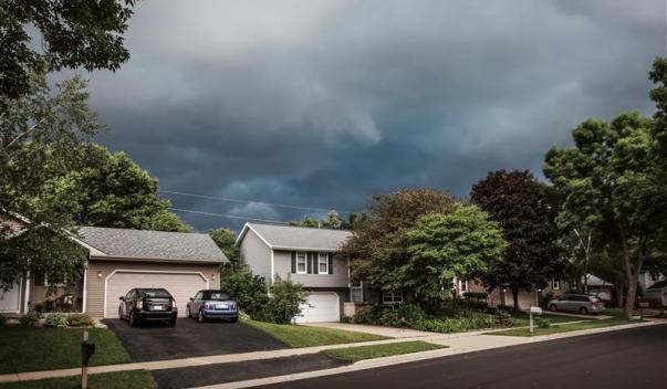 Suburban houses under storm clouds
