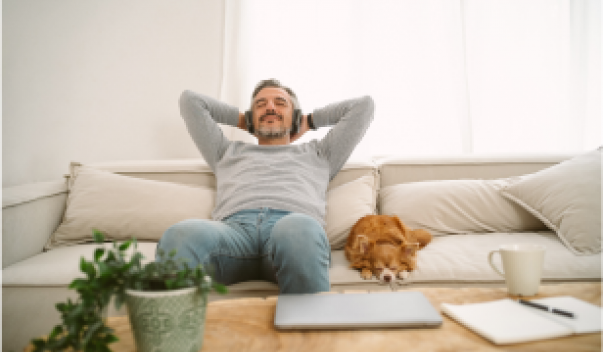 Man relaxing on couch with dog