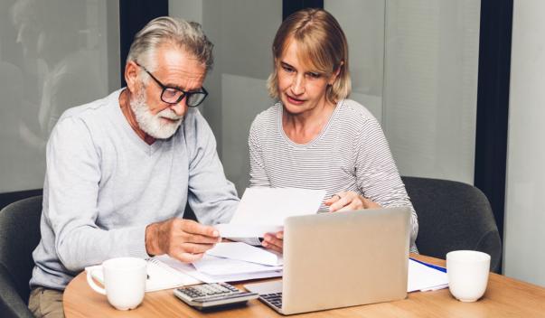 Two people in office reading over documents